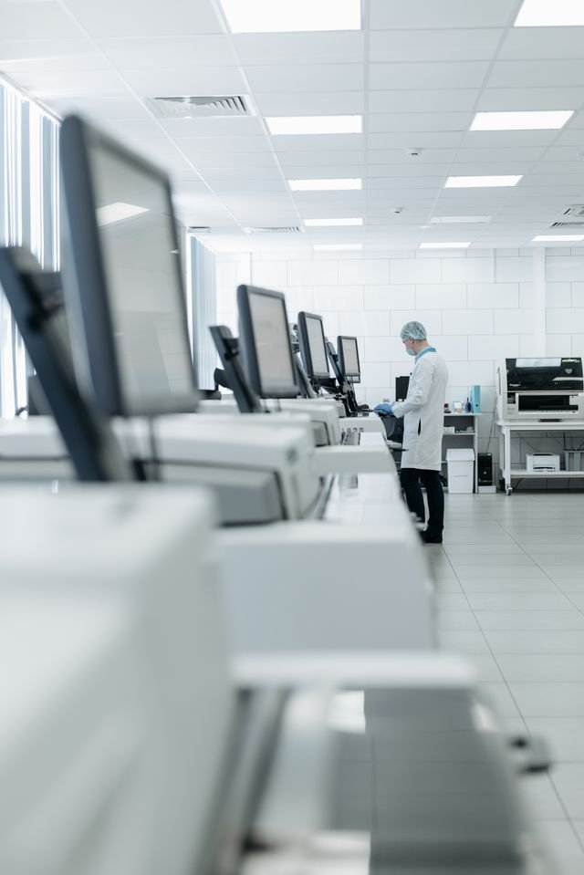 Medical professional in a modern lab using advanced equipment for research.